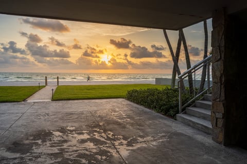 covered patio green lawn pathway leading to beach