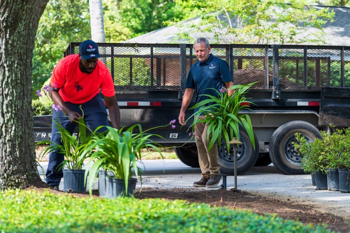 crew carrying plants landscape 2