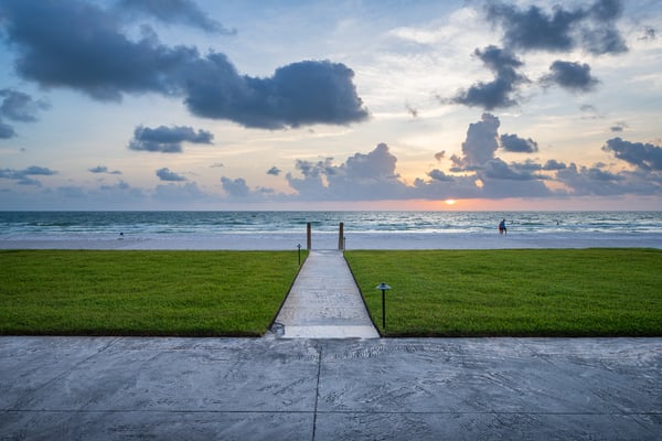patio sidewalk leading to beach green lawn