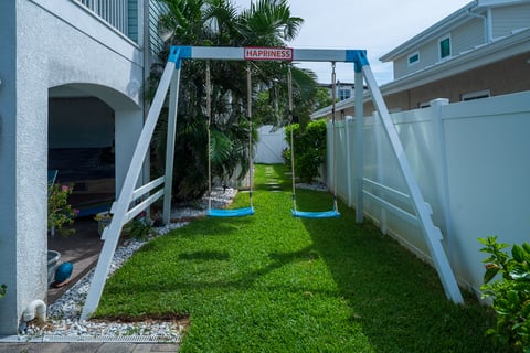 swings green lawn landscape beds