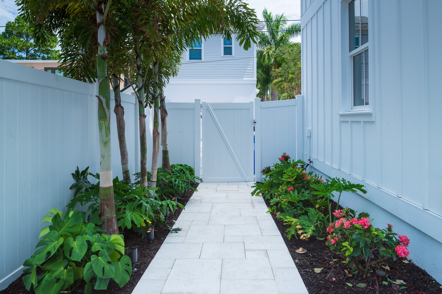 walkway path landscape beds leading to gate