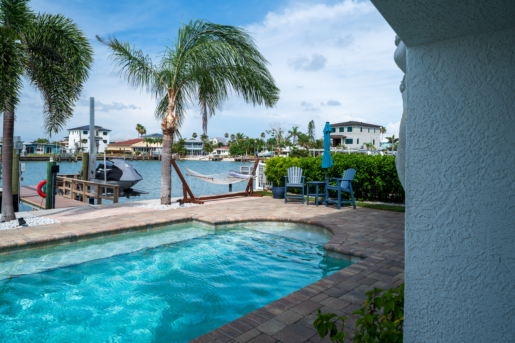 pool near ocean outdoor seating hammock water paver patio